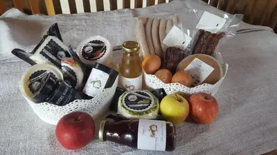 a table with two baskets of food and a bottle of wine at GORIČKE IŽE in Križevci