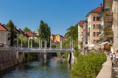 a bridge over a river in a city with buildings at City Center Apartment with Parking in Ljubljana