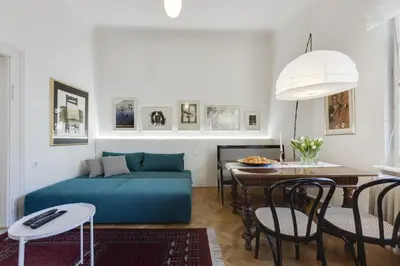 a living room with a blue couch and a table at City Center Apartment with Parking in Ljubljana