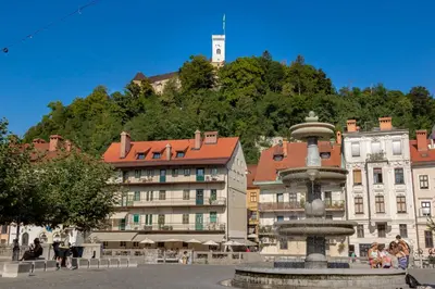 a fountain in a square in front of a building at City Center Apartment with Parking in Ljubljana