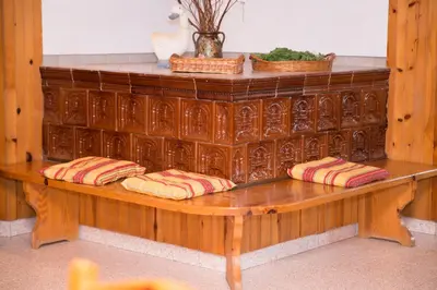 a wooden bench with pillows on top of it at Holiday Farm Grofija in Ivančna Gorica