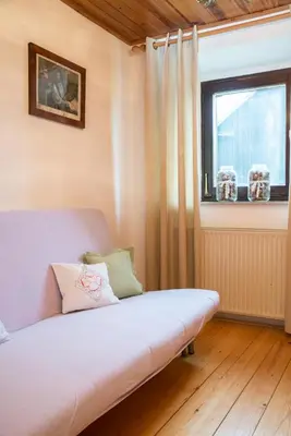 a bedroom with a bed and a window with curtains at Holiday Farm Grofija in Ivančna Gorica