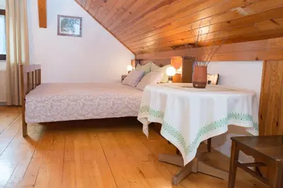 a bedroom with a bed and a table in a room at Holiday Farm Grofija in Ivančna Gorica