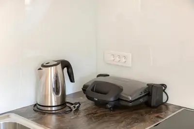 a coffee maker sitting on a counter in a kitchen at Vila Vita Apartments in Kranjska Gora
