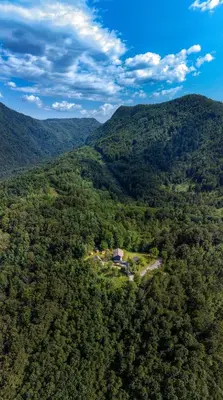 an aerial view of a house in the middle of a forest at Koča sredi gozda in Kanal