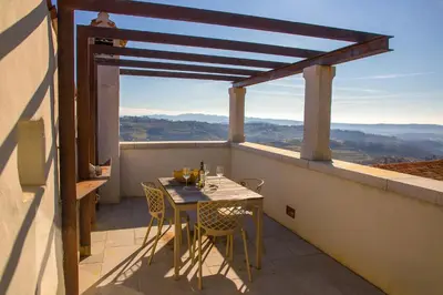 a table and chairs on a balcony with a view at Aldilà Art Rooms, Apartment and Vacation House in Šmartno