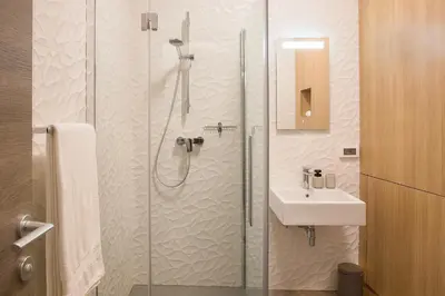 a bathroom with a shower and a sink at Aldilà Art Rooms, Apartment and Vacation House in Šmartno