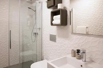a white bathroom with a sink and a shower at Aldilà Art Rooms, Apartment and Vacation House in Šmartno