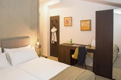 a bedroom with a bed and a desk with a computer at Aldilà Art Rooms, Apartment and Vacation House in Šmartno