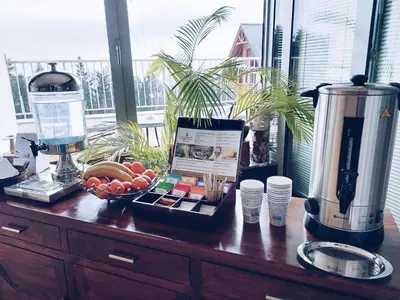 a wooden counter with a blender and fruit on it at Pohorje Village Wellbeing Resort - Family Apartments Bolfenk in Pohorje