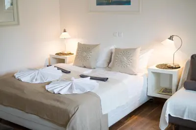 a bedroom with a bed with white sheets and pillows at Bled Apartments in Bled
