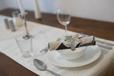 a white bowl with a bow on a table at Bled Apartments in Bled
