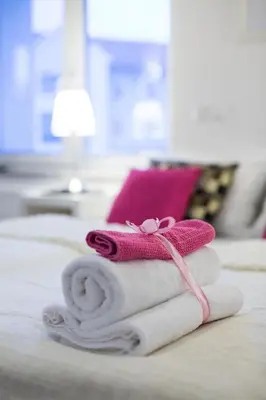 a pile of towels sitting on top of a bed at Bled Apartments in Bled
