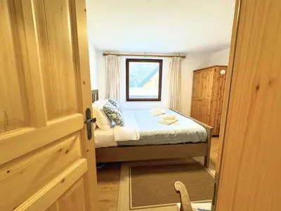 a small bedroom with a bed and a window at Luxury holiday home near Lake Bled & the Alps in Kropa