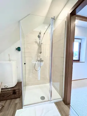 a shower with a glass door in a bathroom at Luxury holiday home near Lake Bled & the Alps in Kropa