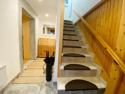 a staircase in a house with an umbrella next to it at Luxury holiday home near Lake Bled & the Alps in Kropa