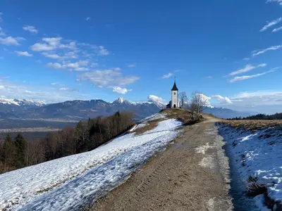 a church on top of a hill with snow at Luxury holiday home near Lake Bled & the Alps in Kropa