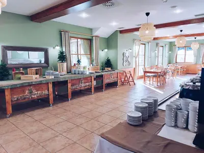 a large room with a kitchen and a dining room at Pohorje Village Wellbeing Resort - Forest Apartments Videc in Pohorje