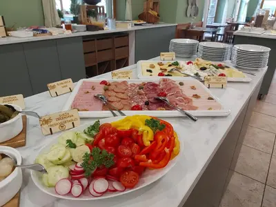 a buffet of different types of food on a table at Pohorje Village Wellbeing Resort - Forest Apartments Videc in Pohorje
