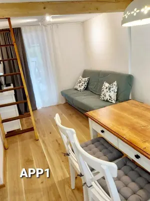 a living room with a couch and a table at Alpine Village Home in Bohinj