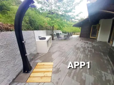 a patio with a wooden floor and a black pole at Alpine Village Home in Bohinj