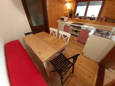 an aerial view of a kitchen with a table and chairs at Alpine Village Home in Bohinj