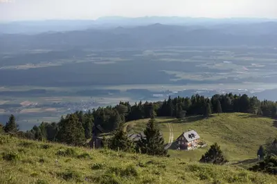 a house on top of a grassy hill with a view at Apartment Jezerca - Krvavec in Cerklje na Gorenjskem
