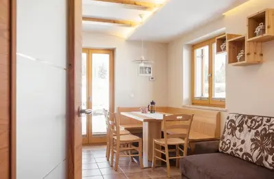 a kitchen and dining room with a table and chairs at Apartment Jezerca - Krvavec in Cerklje na Gorenjskem