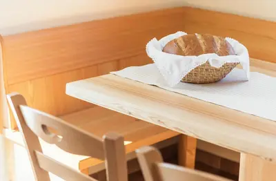a loaf of bread in a basket on a table at Apartment Jezerca - Krvavec in Cerklje na Gorenjskem