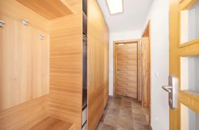a hallway with wood paneling and a door at Apartment Jezerca - Krvavec in Cerklje na Gorenjskem