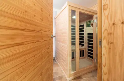 a wooden closet with a glass door in a room at Apartment Jezerca - Krvavec in Cerklje na Gorenjskem