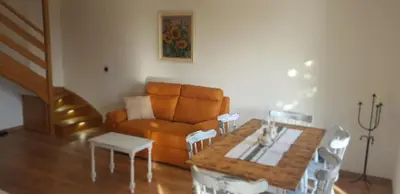 a living room with a couch and a table at Holiday house VilAna in Puconci