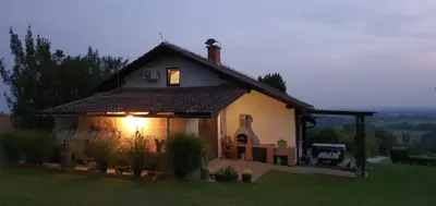 a small house with a light on the side of it at Holiday house VilAna in Puconci