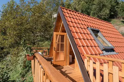 a cabin with an orange roof on a deck at Glamping Tinka in Tolmin