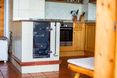 a kitchen with a glass door in a kitchen at Podjelje in Podjelje