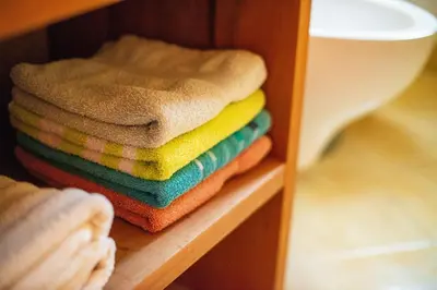 a pile of towels are stacked on a shelf at Podjelje in Podjelje