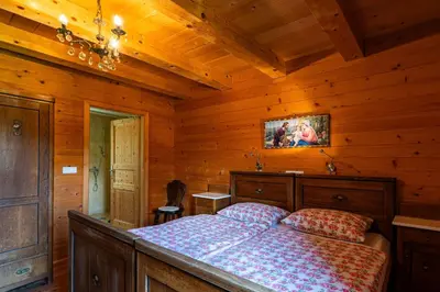 a bedroom with a bed in a log cabin at Podjelje in Podjelje