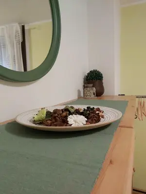 a plate of food on a counter with a mirror at apartma MAKS - Kobarid in Podbela