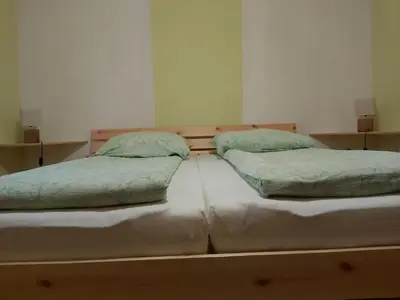 two twin beds sitting next to each other in a room at apartma MAKS - Kobarid in Podbela