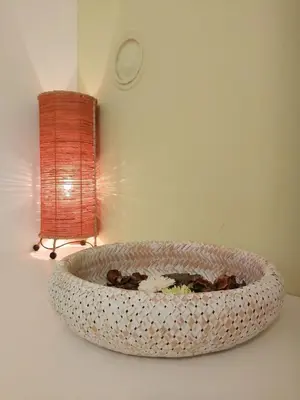 a bowl with flowers in it next to a lamp at apartma MAKS - Kobarid in Podbela