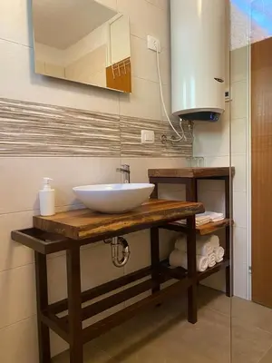a bathroom counter with a sink and a mirror at apartma MAKS - Kobarid in Podbela