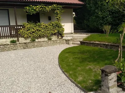 a house with a yard with a gravel driveway at apartma MAKS - Kobarid in Podbela