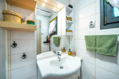 a small bathroom with a sink and a mirror at Boho House 2 camp Terme Catez with promotional tickets prices in Čatež ob Savi