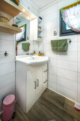 a bathroom with a sink and a mirror at Boho House 2 camp Terme Catez with promotional tickets prices in Čatež ob Savi