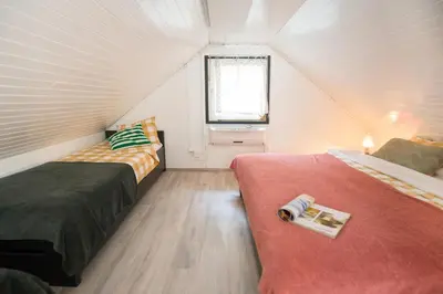 a bedroom with two beds and a window in it at Boho House 2 camp Terme Catez with promotional tickets prices in Čatež ob Savi