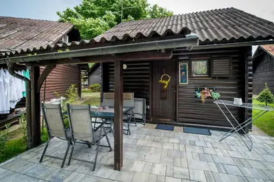 a patio with a table and chairs in front of a cabin at Boho House 2 camp Terme Catez with promotional tickets prices in Čatež ob Savi