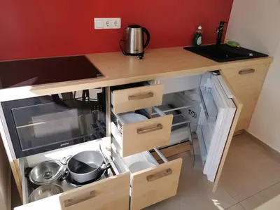 a kitchen with a counter with open drawers at Cube studio by the river (with free bike rental) in Ljubljana