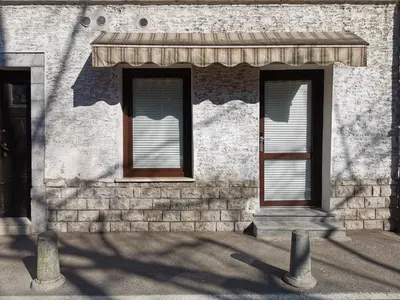 two windows on the side of a building at Cube studio by the river (with free bike rental) in Ljubljana