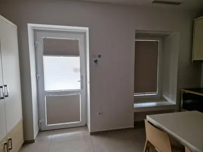 an empty room with a door and a window at Cube studio by the river (with free bike rental) in Ljubljana