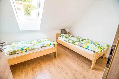 two twin beds in a room with a window at Holiday Home BOR in Podčetrtek